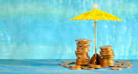 wealth management or rising prices for vacation concept,heap of coins and sun umbrella, free copy...
