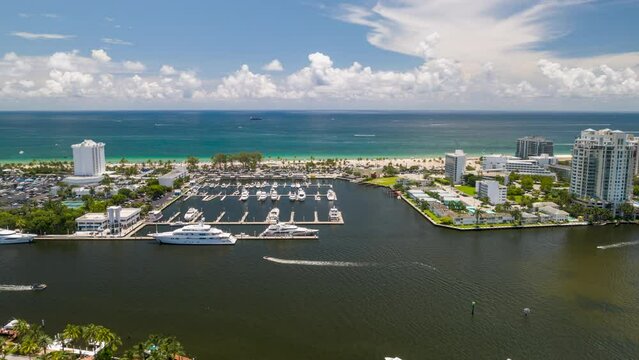 Aerial hyper lapse above canal with boats towards Fort Lauderdale  beach, Florida
