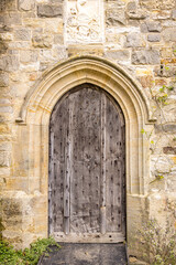 Fototapeta na wymiar Old arched doorway with wooden door