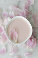 cup of a  pink drink with pink flower background