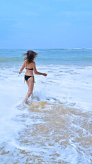 Fototapeta na wymiar Woman running on the atlantic beach.