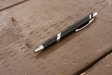 ball point pen on a brown wooden table