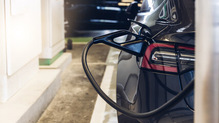 Renewable Energy Concept. Electric car charging station. Hybrid car Electric charger station in the Car Park. Electric car charging on parking and charging station. Electric socket. Transportation EV.