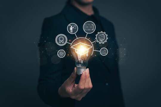 Light bulb in hand that glows. Concept of people finding new ideas in study and education. Business people looking for ideas to work after graduation with internet technology.