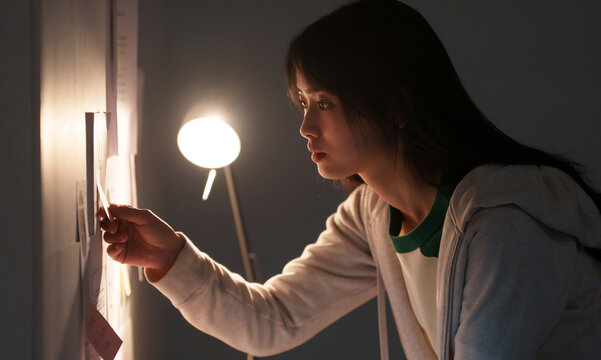 Female university student studying at night