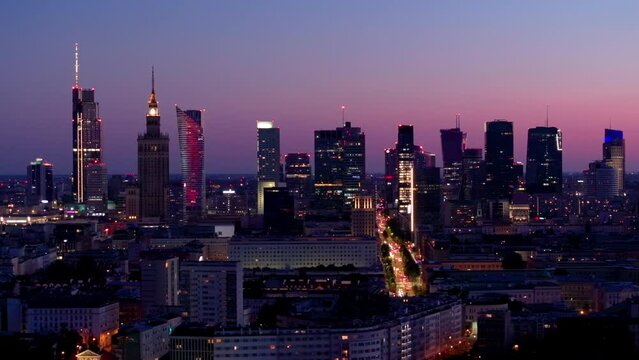 Aerial view of Warsaw Poland, at night. Warsaw business center at night: skyscrapers and Palace of Science and Culture. Drone footage of warsaw center at night. 