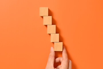 Hand with wooden cubes mock up on abstract background, Copy space, Wooden blocks with copy space for text or symbols, Background with copy space