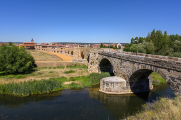 Fototapeta na wymiar Summer's Awakening: Unveiling the Roman Bridge along the Camino de Santiago in Hospital de Orbigo, Leon, Spain