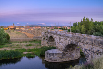 Summer's Awakening: Unveiling the Roman Bridge along the Camino de Santiago in Hospital de Orbigo,...