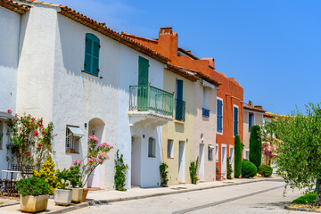 Fototapeta na wymiar Colorful houses in Port Grimaud, village on Mediterranean sea with yacht harbour, Provence, summer vacation in France