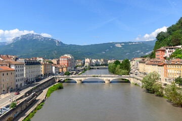 View on central part of Grenoble city from Bastille fortres witn mountains around, old cable car, Isere, France