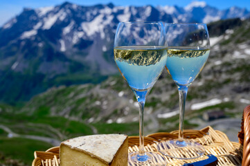Cheese and wine, dry white Roussette de Savoie or Vin de Savoie wine from Savoy region with tomme...