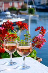 Glasses of cold rose Cote de Provence wine in yacht harbour of Port Grimaud, summer vacation on French Riviera in Provence, France