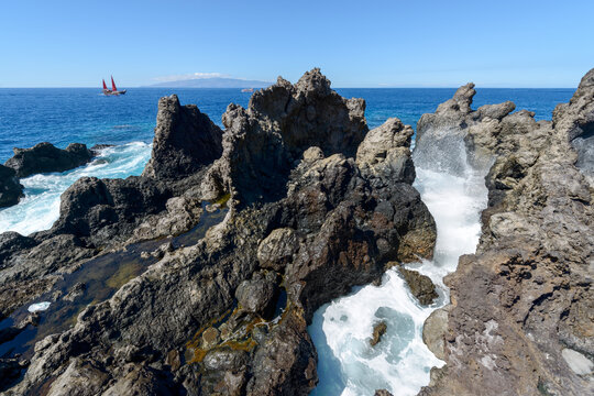Ocean wave among volcanogenic rocks of cape Barbero, Tenerife, Canary.