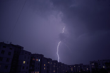 lightning in the city struck behind a high-rise building