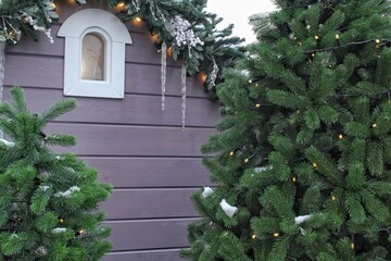 Christmas porch decoration idea. House entrance and window sill decorated for holidays. New year...