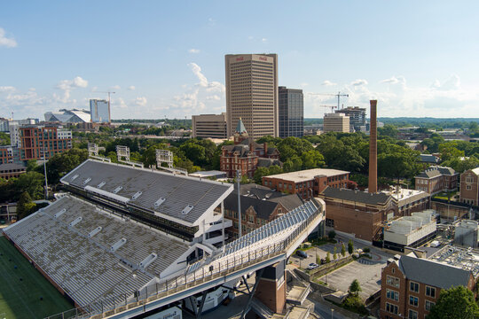 aerial shot of skyscrapers and office buildings in the city skyline, the Georgia Institute of Technology campus, Bobby Dodd Stadium, Mercedes-Benz Stadium, lush green trees Atlanta Georgia USA