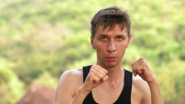 young man throwing a left-handed punch directly at the camera
