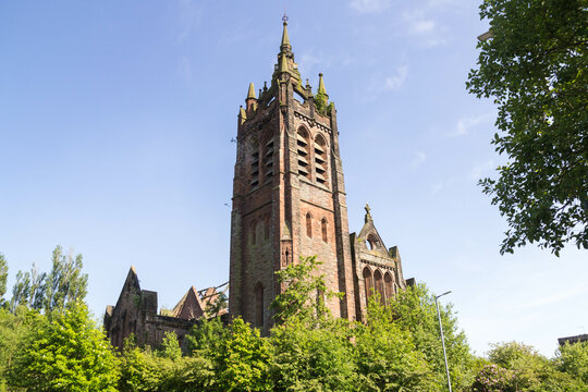 Iconic Tower Remains of Dundyvan Parish Church in Coatbridge, Scotland. A Ruined and Fire Damaged Striking Gothic style Scots Revival church in red sandstone built in 1905