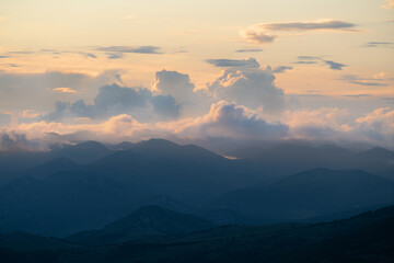 Evening mood with dramatic clouds over a hilly landscape on the Croatian coast.