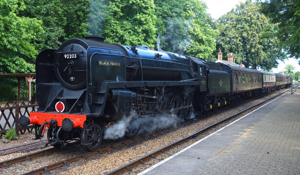 Vintage British Railways BR Standard Class 9F 2-10-0  steam locomotive  "Black Prince" at station.