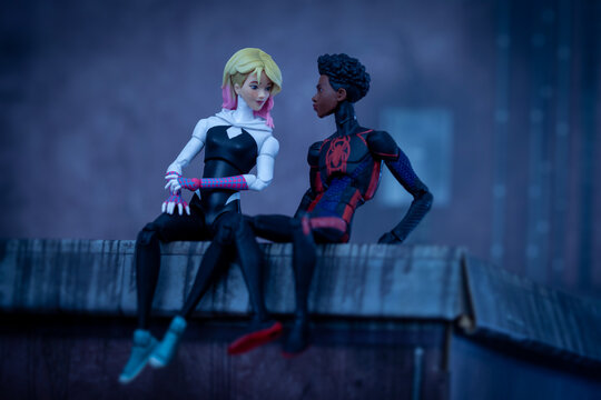 NEW YORK USA, AUG 1 2023: Marvel comics Spider-verse Miles Morales and Gwen Stacy sitting on an urban rooftop - Hasbro action figures