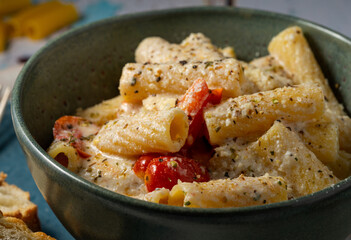 Rigatoni pasta with cherry tomatos and ricotta sauce.