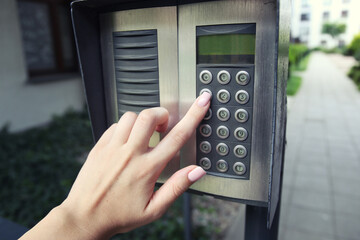 Woman hand pressing the security code combination to unlock the door