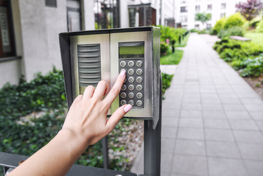 Woman hand pressing the security code combination to unlock the door