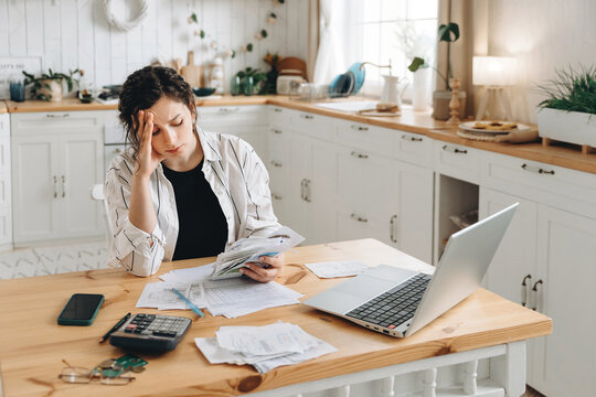 Stressed caucasian woman trying to deal with financial documents, having problem to find money to pay utility bills or loans. The concept of debt, bankrupt. Accounting companies advertisement mockup