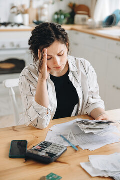 Stressed caucasian woman trying to deal with financial documents, having problem to find money to pay utility bills or loans. The concept of debt, bankrupt. Accounting companies advertisement mockup
