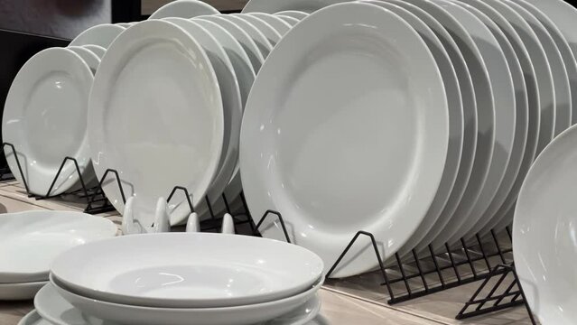 New white round plates are in the crockery store or tableware shop