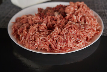 A bowl of Minced meat on black background
