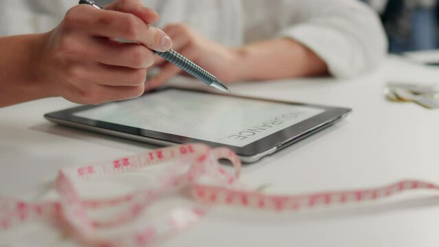 Contract, Efficient administrator Explains the clauses of the contract on an electronic tablet In a meeting room Consultant girl Demonstrates a digital life insurance policy. At the insurer's office

