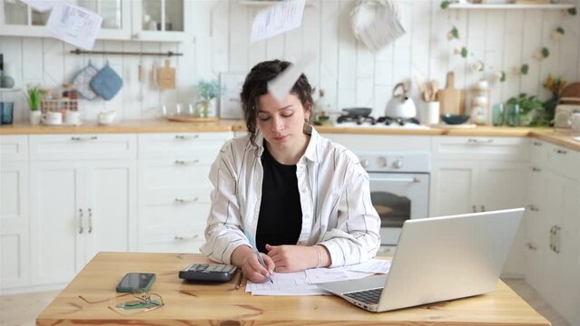 Confident woman successfully deals with financial documents, paying utility bills or loans on her own. Receipts and bills rain down on the woman's head. Advertising mockup for accounting companies