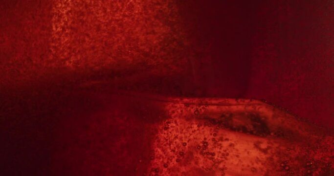 Refreshing Ice Red Alcohol Drink. Glas of colorful refreshing ice cocktail. Coca Cola Ice Macro shot