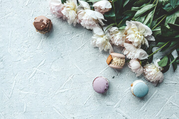 Fototapeta na wymiar Beautiful summer wallpaper, background with place for your text, macarons and peonies