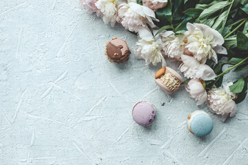 Fototapeta na wymiar Beautiful summer wallpaper, background with place for your text, macarons and peonies