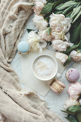 Cup of coffee, sweet macaroons and white peonies, beautiful aesthetic photo
