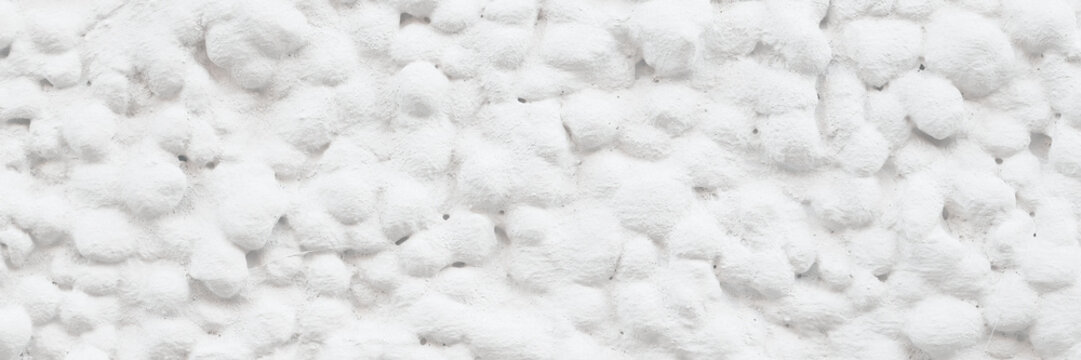 The texture of the gray wall. Decorative plaster.  Rough grainy bumpy surface. Perfect for background and design. Closeup.