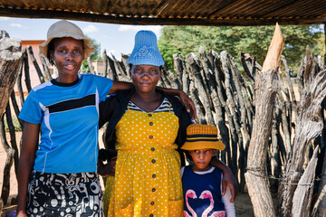 village african family and child standing under the metal shed
