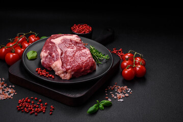 Fresh, raw beef steak with salt, spices and herbs