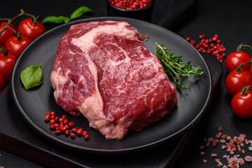 Fresh, raw beef steak with salt, spices and herbs