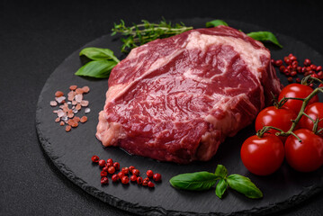 Fresh, raw beef steak with salt, spices and herbs