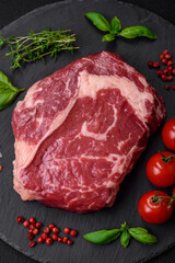 Fresh, raw beef steak with salt, spices and herbs