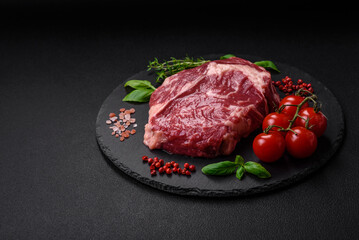 Fresh, raw beef steak with salt, spices and herbs