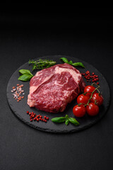 Fresh, raw beef steak with salt, spices and herbs