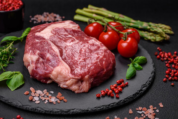 Fresh, raw beef steak with salt, spices and herbs