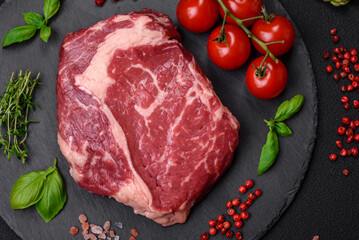 Fresh, raw beef steak with salt, spices and herbs