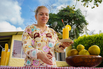 Obraz premium Woman drinking orange juice in the morning